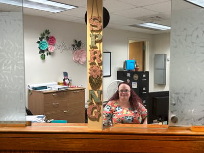 Reception area with a smiling staff member