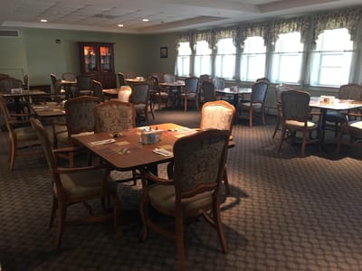 Dining area with tables and chairs in a cozy setting