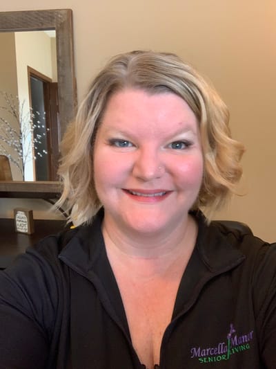 Staff member smiling in the facility's common area