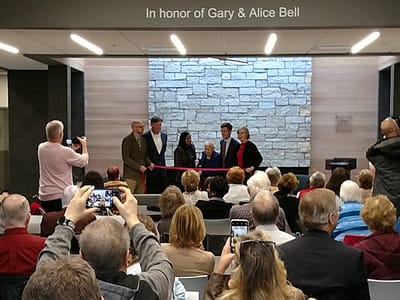 Ribbon-cutting ceremony with attendees in a common area