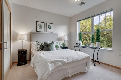 A well-lit bedroom in a senior living facility