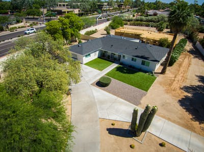 Aerial view of a senior living facility with green lawn