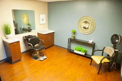 A well-lit salon area with styling chairs and mirrors