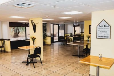 Dining area with tables and chairs in a well-lit space