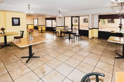 Bright dining area with tables and flowers