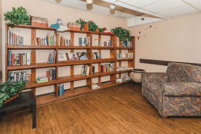 Cozy reading area with bookshelves and a comfortable chair