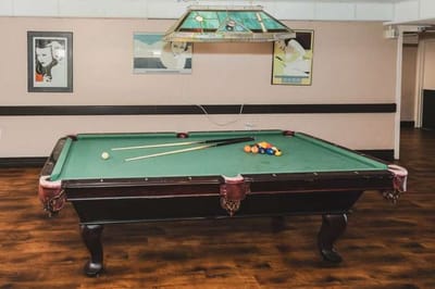 A billiards table in a recreation room