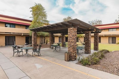 Outdoor seating area with tables and chairs