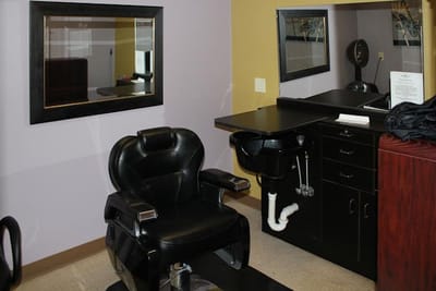 Interior view of a salon area with a hairdressing chair