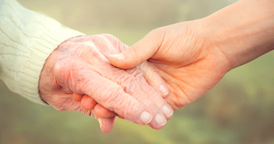 Two hands clasped together, symbolizing care