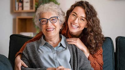 Senior woman with caregiver smiling together