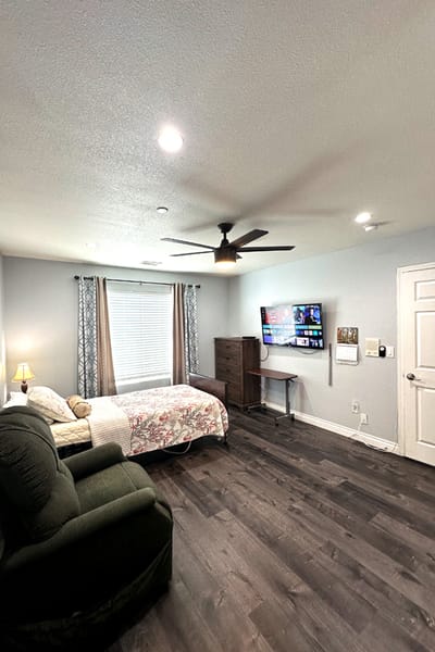 Cozy resident room with a bed and TV