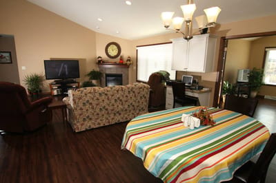 A cozy common area with a striped tablecloth and furnishings