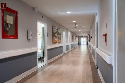 Well-lit hallway in a senior living facility
