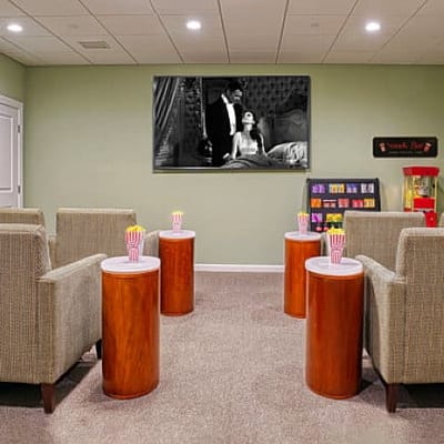Interior of a common area with seating and a screen