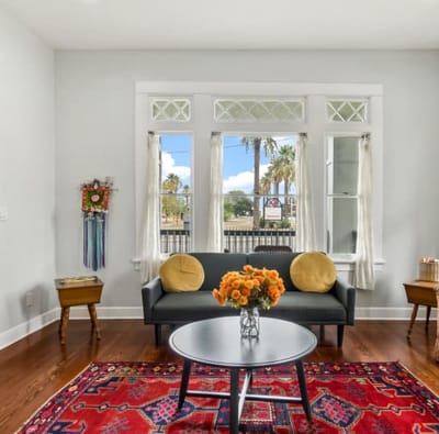 Bright interior lounge area with a cozy sofa and flowers