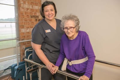 Smiling staff member assisting a resident