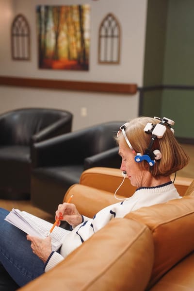 Resident engaged in a cognitive activity in the lounge