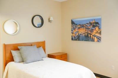 Cozy bedroom with artwork and mirrors
