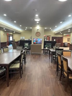 Avita Assisted Living and Memory Care, assisted living in Wichita, KS — Common area with dining tables and television