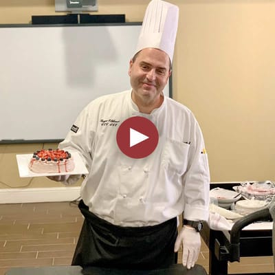 Chef presenting a dessert in the dining area
