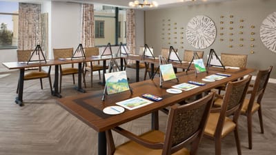 Art studio with easels and painting supplies for residents