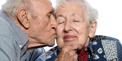 An elderly couple sharing a tender moment together