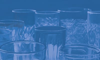 Close-up of various glassware on a blue background