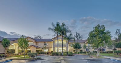 Exterior view of a senior living facility with landscaping
