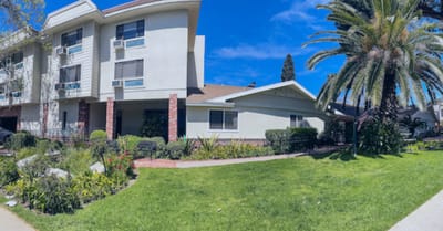 Exterior view of a senior living facility with landscaped gardens