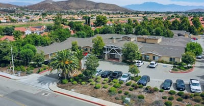 Aerial view of the facility with gardens and parking area