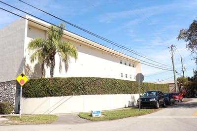 Exterior view of a senior living facility with landscaping.