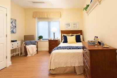 Cozy private resident room with bed and decor