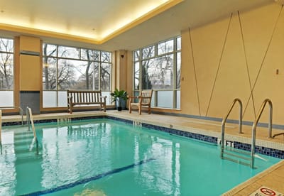 Indoor pool area with benches and large windows