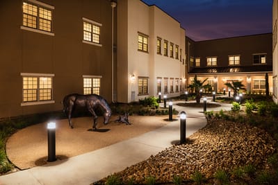 Pathway in outdoor area with landscaping and statues