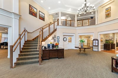 Welcoming lobby area with staircase and decorations