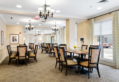 Bright dining area with tables and chairs set up