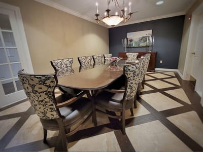 Elegant dining room with a long table and floral chairs