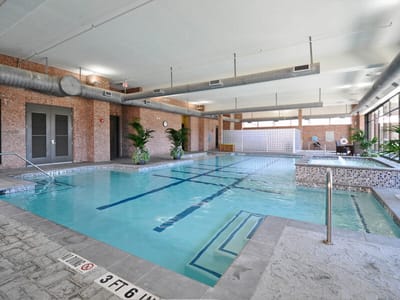 Indoor swimming pool area with lounge chairs