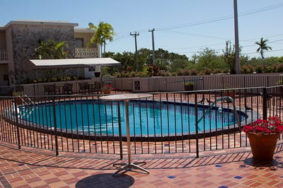 Swimming pool area with surrounding patio and landscaping