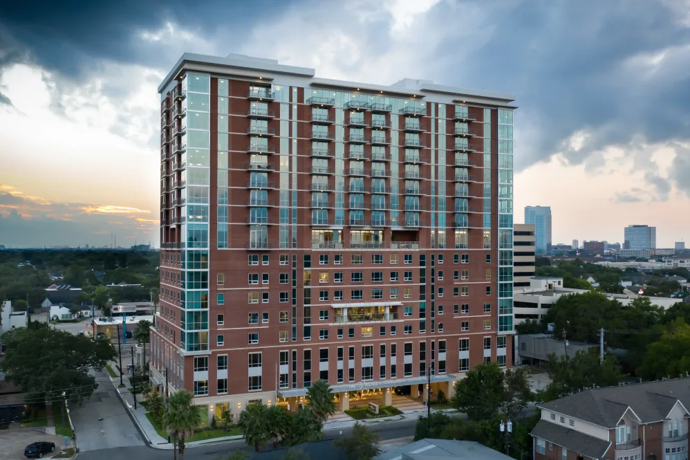 Exterior view of The Village of Southampton building at dusk