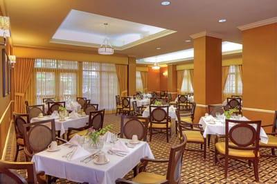 Interior view of a bright dining room with tables set up
