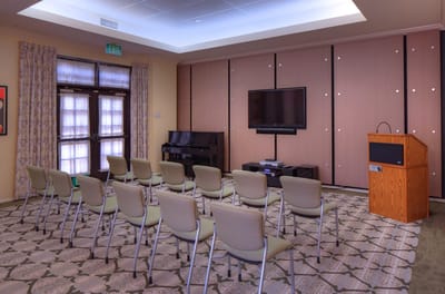 Interior activity room with chairs and a podium