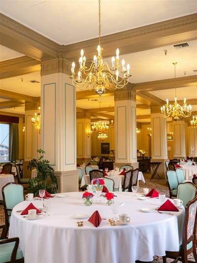 Elegant dining room with chandeliers and table settings