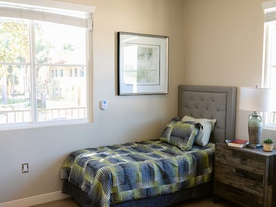 Cozy private resident room with a bed and artwork