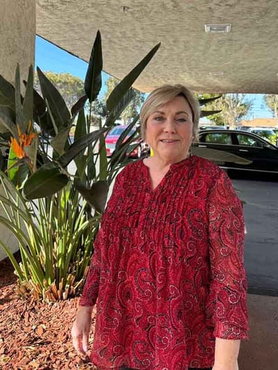 Resident standing outdoors near plants
