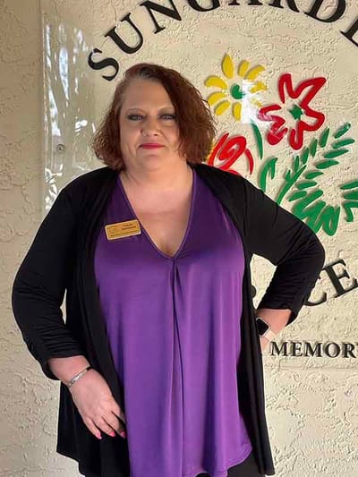 Staff member posing at facility entrance