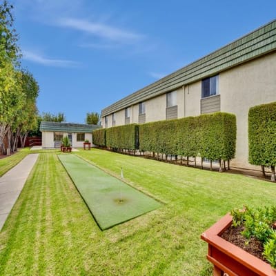 Outdoor putting green with building in background