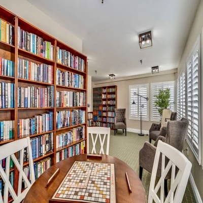 Cozy common area with bookshelves and seating.