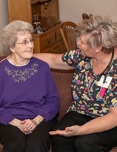 Caregiver interacting with a resident in a cozy living area